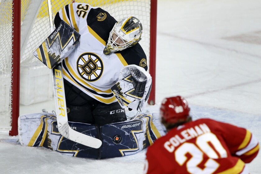 Boston Bruins goalie Linus Ullmark makes a save against Calgary Flames' Blake Coleman during the first period of an NHL hockey game Saturday, Dec. 11, 2021, in Calgary, Alberta. (Larry MacDougal/The Canadian Press via AP)