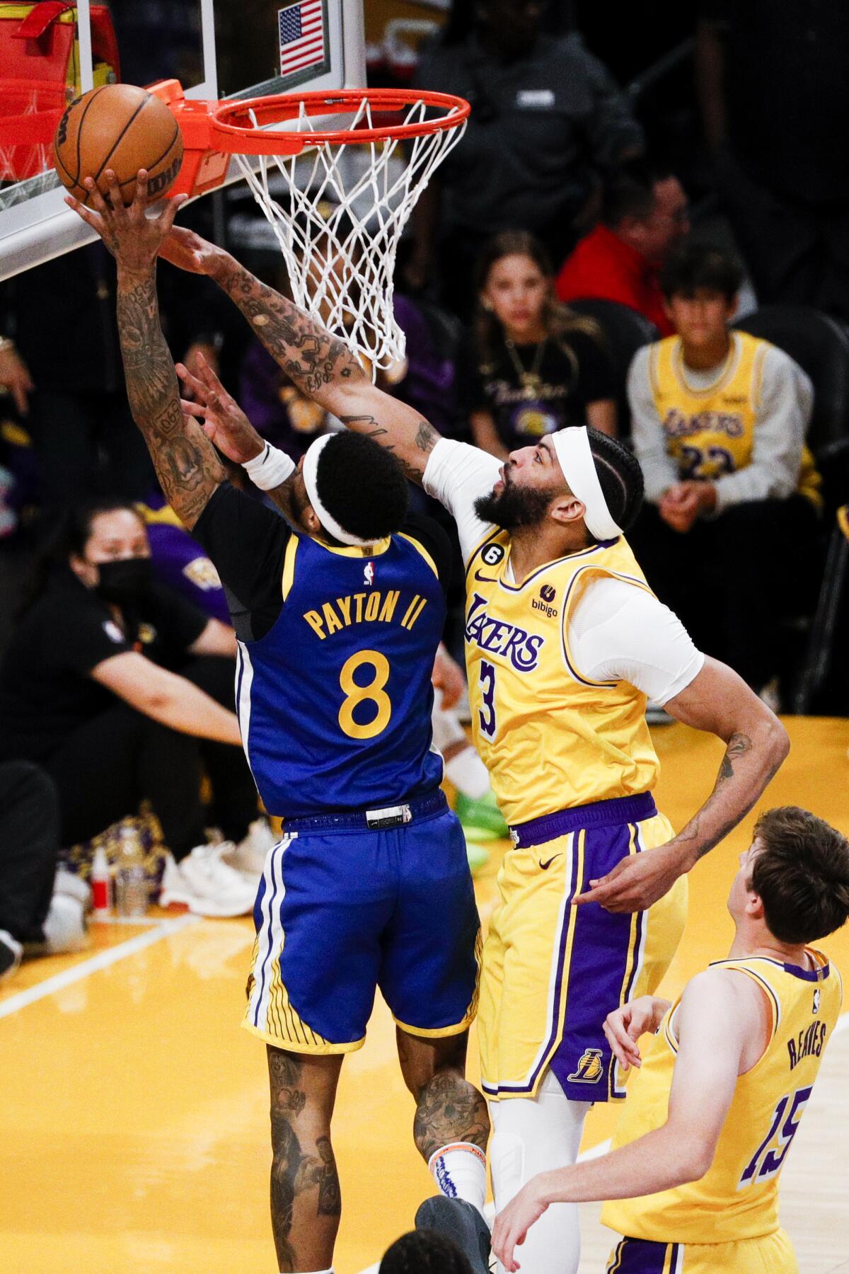 Lakers forward Anthony Davis, right, jumps to try to block a shot by Warriors guard Gary Payton II.