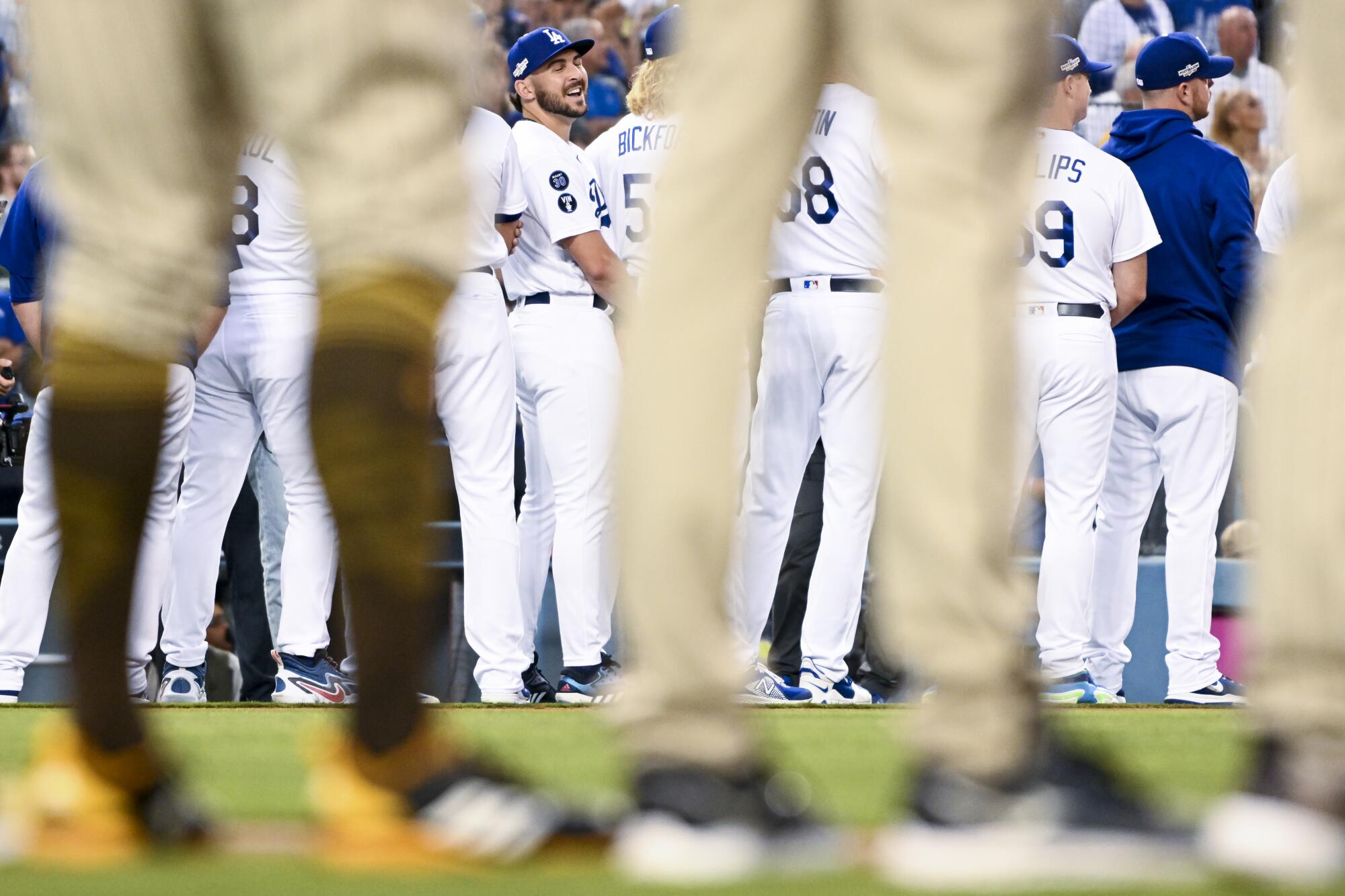 Dodgers relief pitcher Alex Vesia, center, laughs while players are introduced.