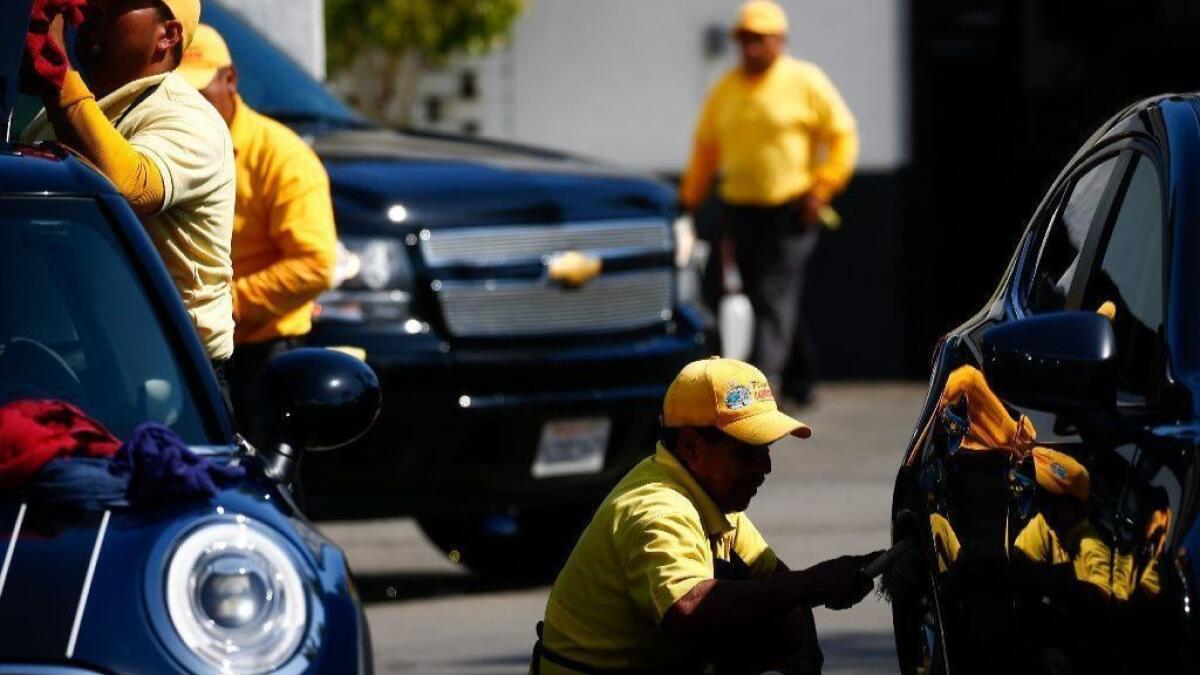 Cars are washed and dried at the Playa Vista Car Wash in Culver City owned by auto dealership mogul Hooman Nissani.