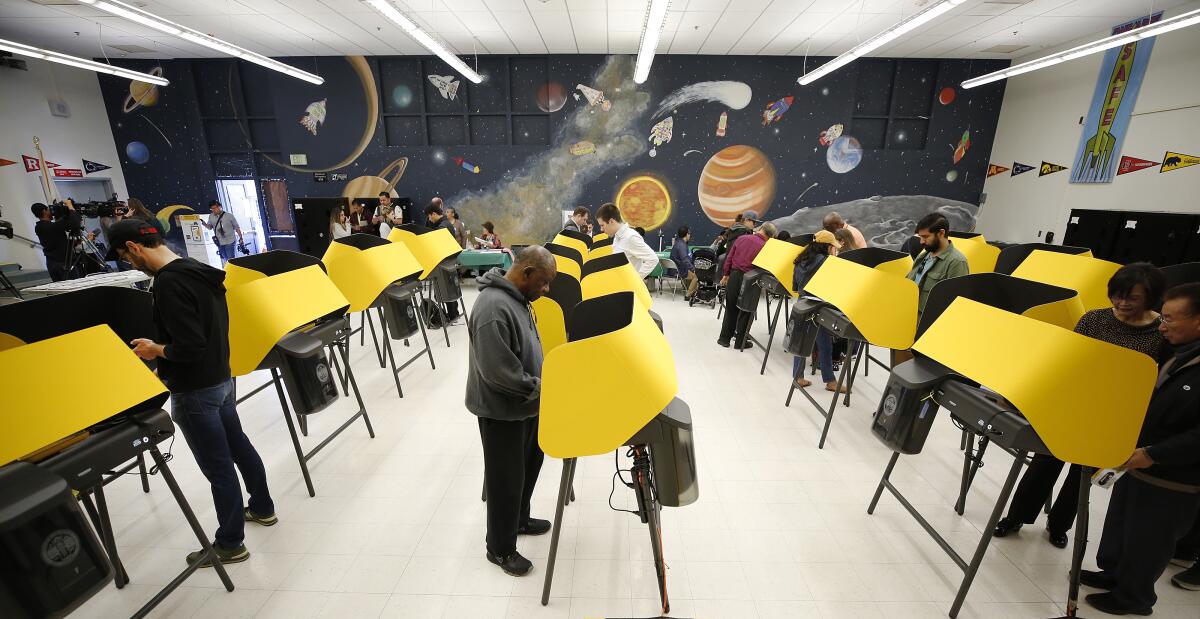 Voters use the new voting machines at Wilshire Park Elementary School in the Mid-Wilshire neighborhood on March 3, 2020.