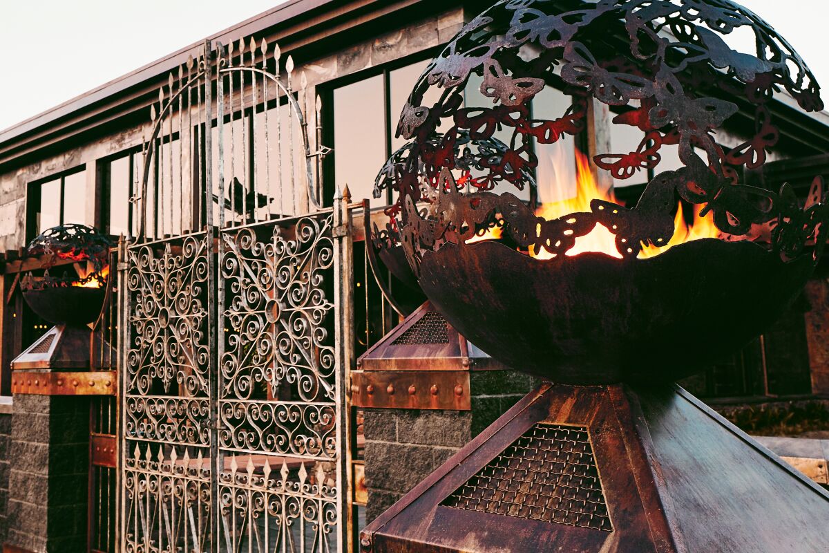 Mariposa restaurant exterior features a sculpture emitting fire.