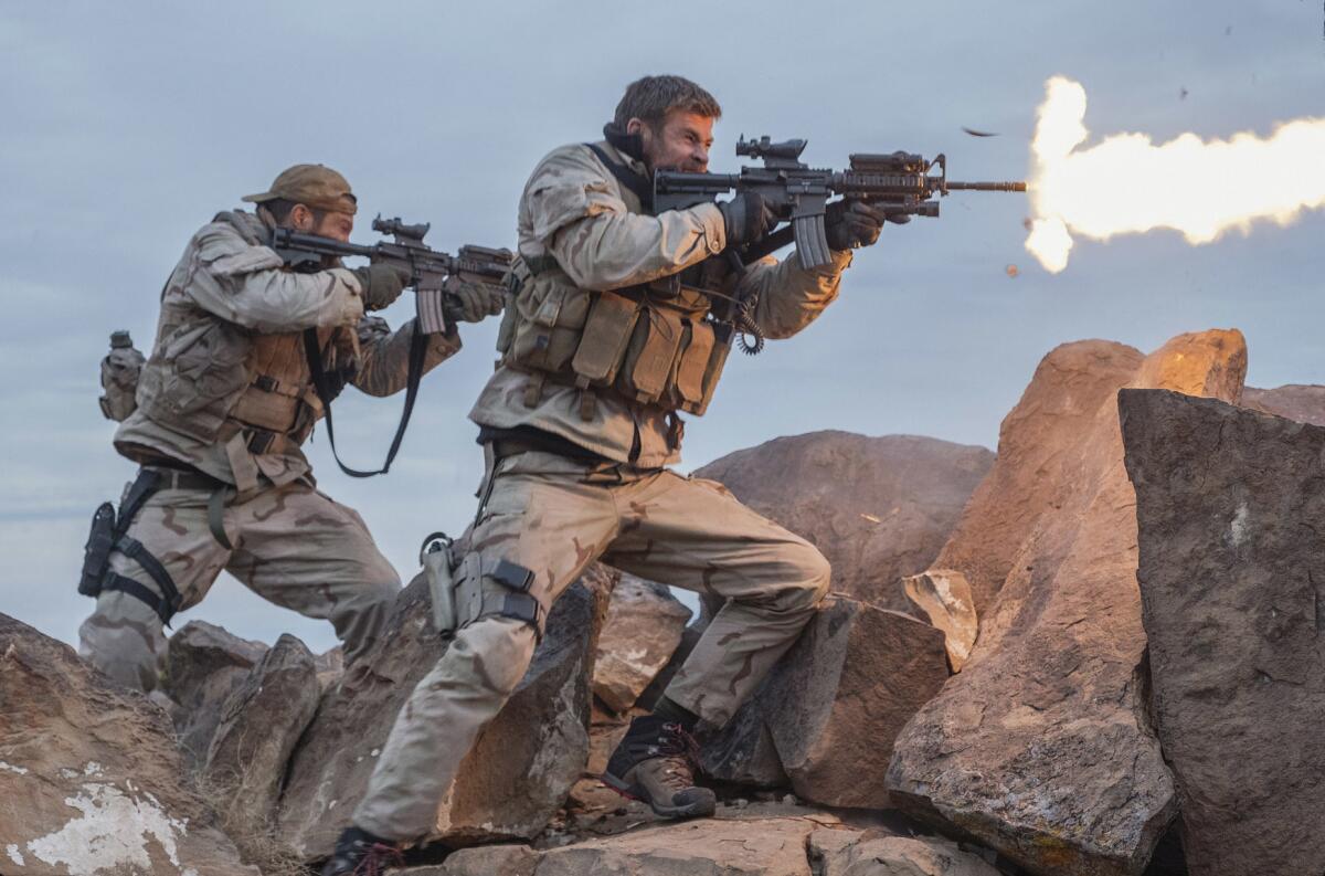 Geoff Stults, left, and Chris Hemsworth in a scene from "12 Strong."