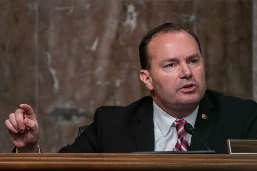 Sen. Mike Lee of Utah is photographed in close-up as he asks questions from a dais