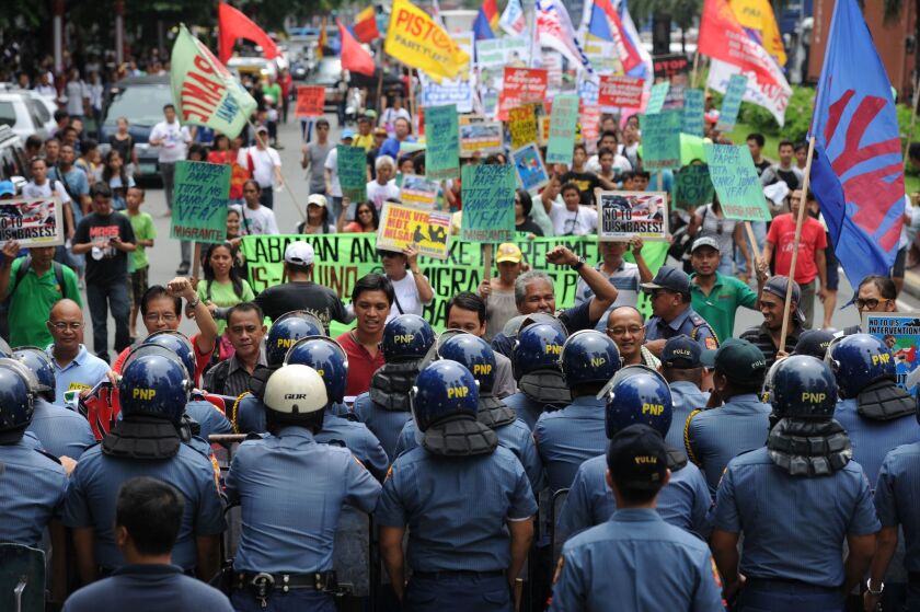 More than 20 years after U.S. bases in the Philippines were closed and the bulk of the foreign troops sent home, some Filipinos remain opposed to their return despite mounting concerns about China's might and the region's myriad territorial disputes. Riot police hold back protesters in this scene from Manila last month, when the government first floated the idea of revising the Visiting Forces Agreement to boost the U.S. presence.