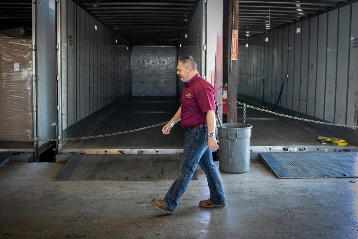 Greg Dubuque walks through the loading dock where trailers wait to be filled