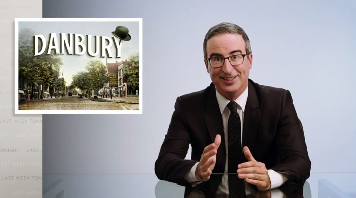 This video frame grab shows John Oliver from his "Last Week Tonight with John Oliver" program on HBO, Sunday, Aug. 30, 2020. On Saturday, Aug. 22, 2020, Danbury, Conn., Mayor Mark Boughton announced a tongue-in-cheek move posted on his Facebook page to rename Danbury's local sewage treatment plant after Oliver following the comedian's expletive-filled rant about the city. Oliver has upped the stakes, on his program, Sunday, offering to donate $55,000 to charity if the city actually follows through on a joke to name its sewage treatment plant after him. (HBO via AP)