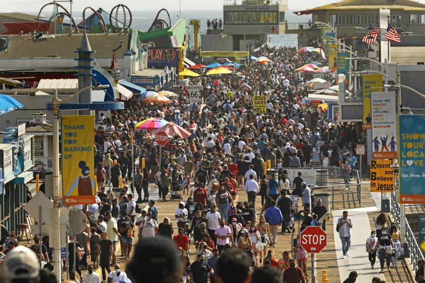 Santa Monica, CALIFORNIA—May 30, 2021--People flock to Santa Monica Pier and Santa Monica beach on Memorial Day, May 30, 2021. (Carolyn Cole / Los Angeles Times)