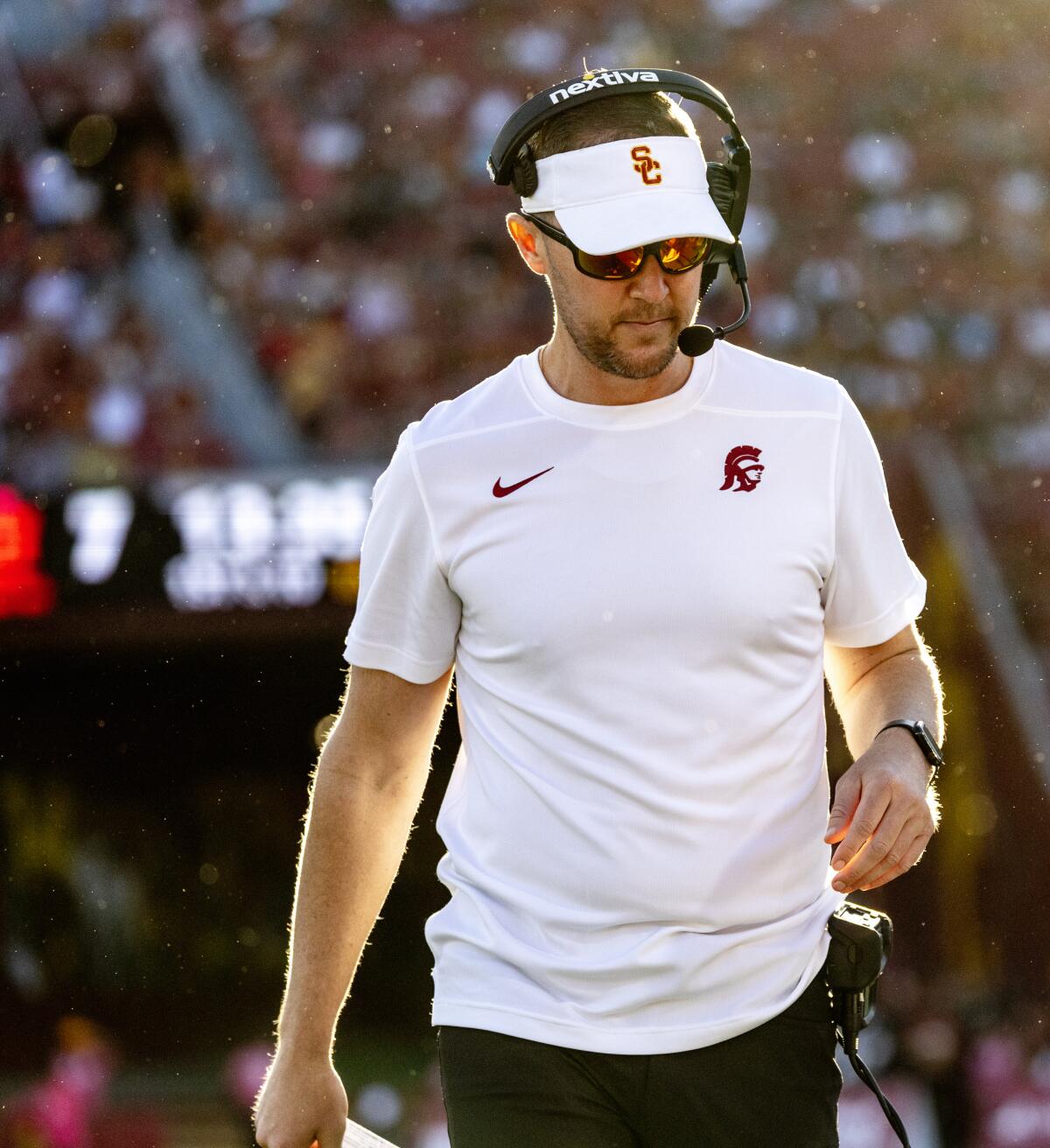 Lincoln Riley walks on the sidelines.
