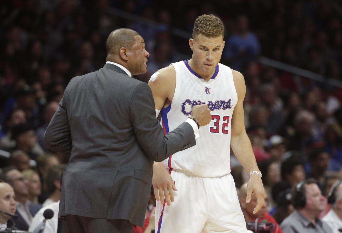 Clippers Coach Doc Rivers talks to Blake Griffin during a game against the Lakers on April 7.