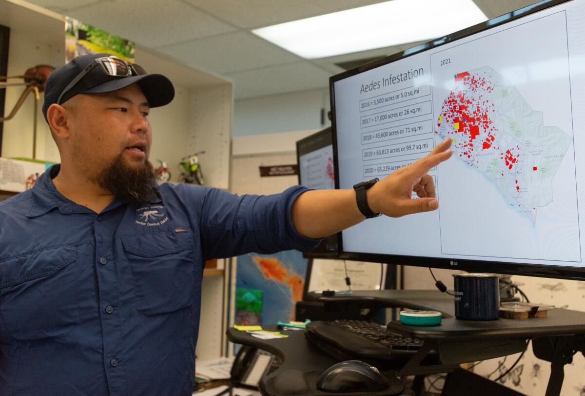 Kiet Nguyen goes over data showing the spread of an invasive species of mosquito in Orange County.