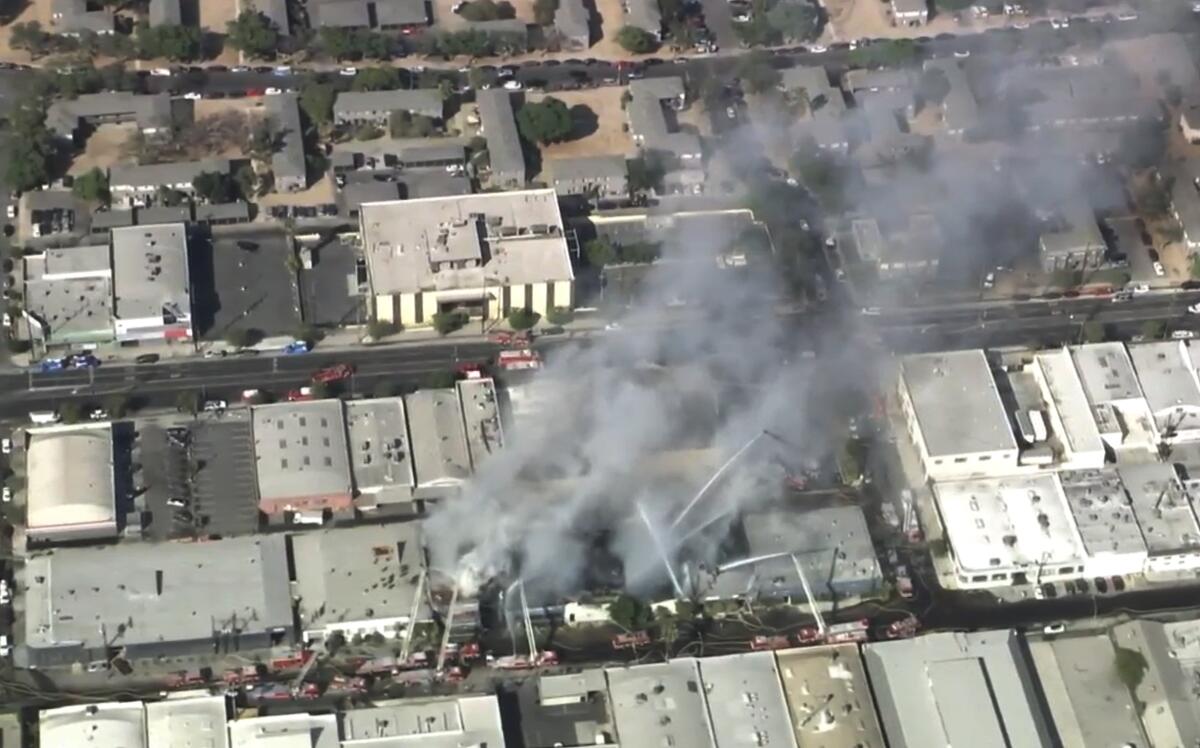An aerial view of smoke rising from buildings