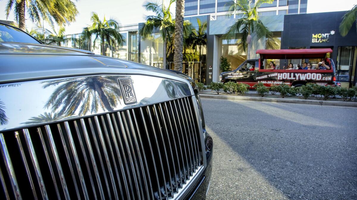 A Rolls Royce is parked on Rodeo Drive in 2013. 