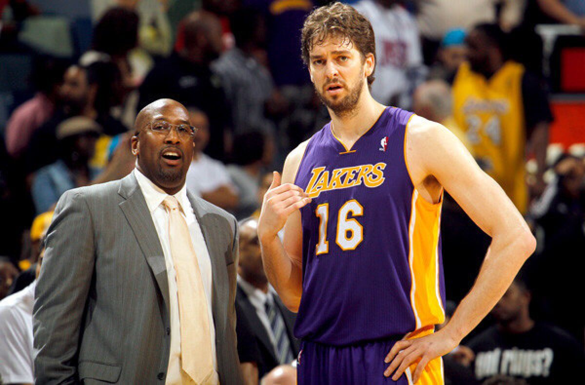Lakers power forward Pau Gasol chats with Mike Brown during a timeout in a game against the New Orleans Hornets last season.