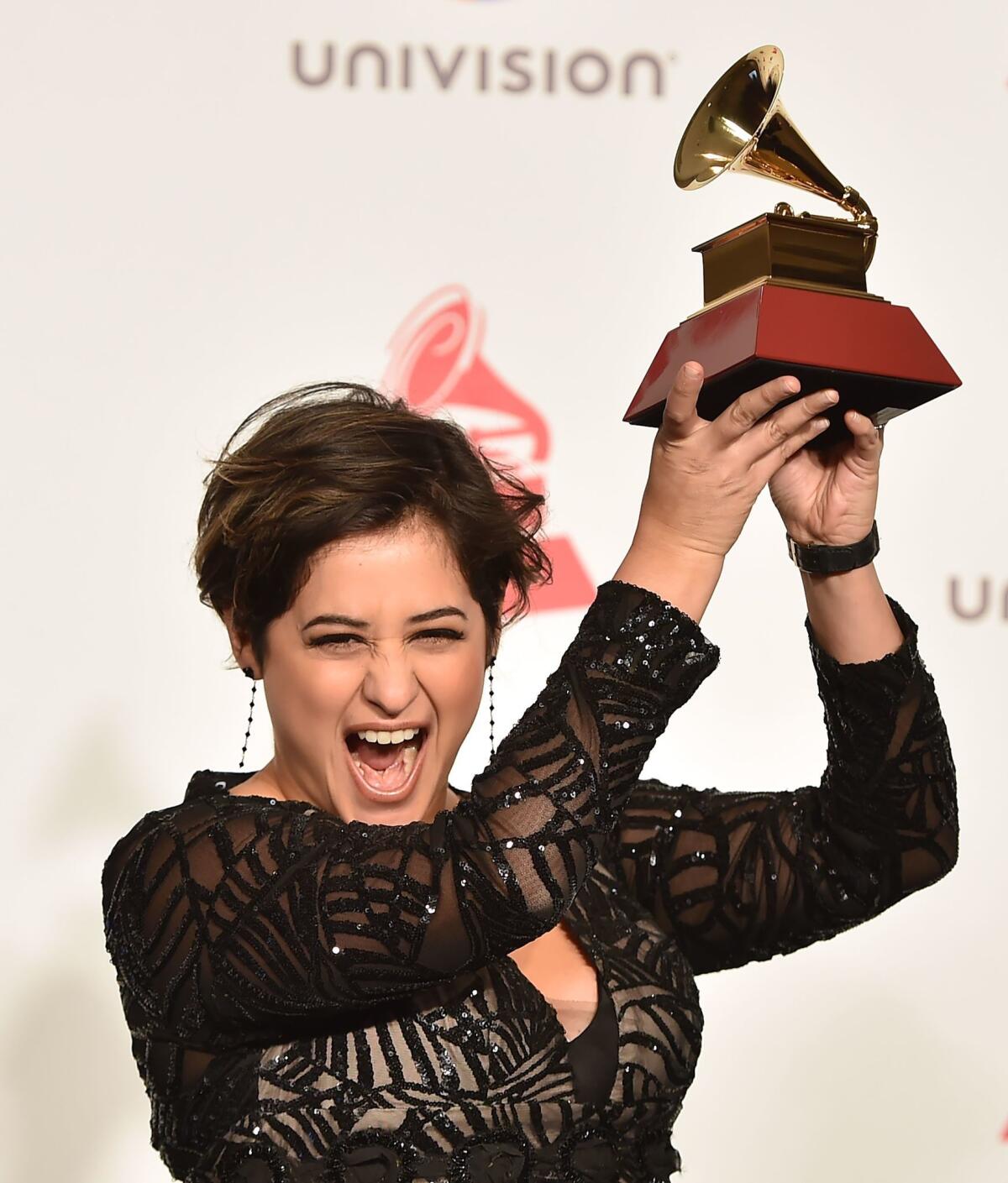 Linda Briceno holds the Latin Grammy for Producer of the Year during the 19th Latin Grammy Awards.