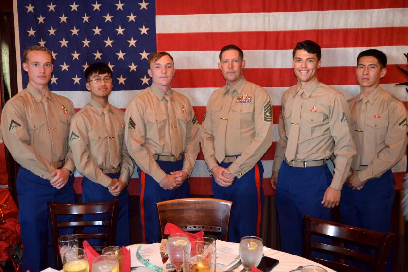 FirstT Sgt. Garrett Jolly third from right is flanked by Marines at Gulliver's restaurant.