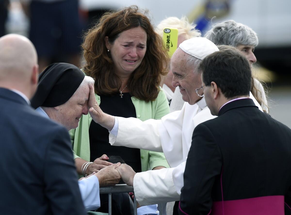 Pope Francis stops to meet people after arriving at Philadelphia International Airport.