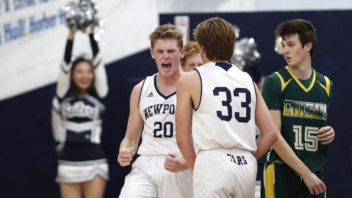 Newport Harbor's Sam Barela (20) celebrates after a shot went in late against Edison on Monday. Barela finished with 24 points, five rebounds and three steals.