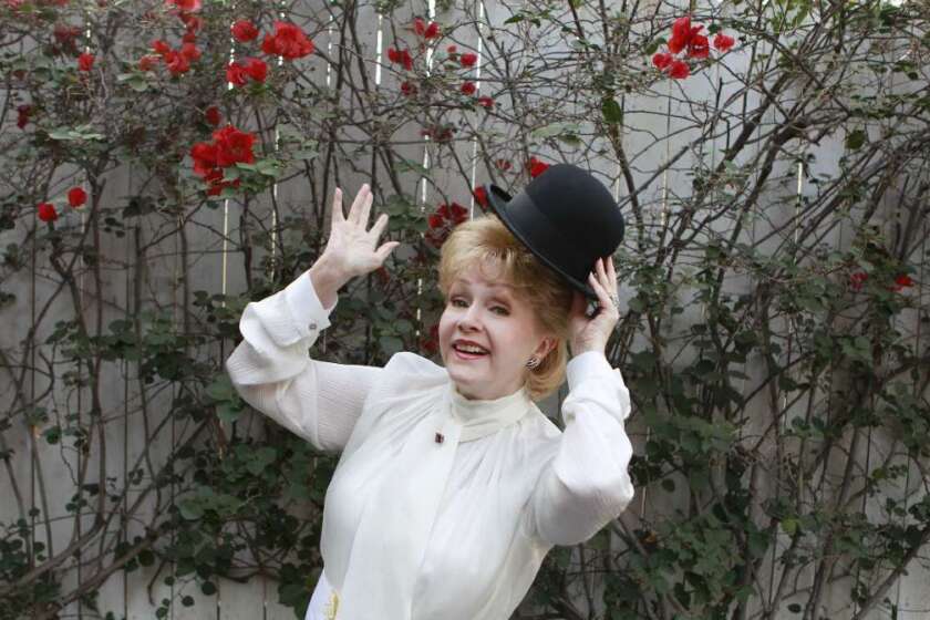 Debbie Reynolds at her Los Angeles home in 2012, clowning with Charlie Chaplin's hat.