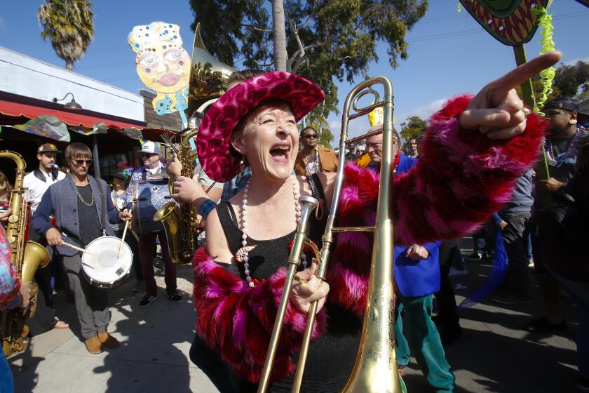 April West along with her trombone were part of the Euphoria Brass Band that led the group down El Cajon Blvd., for the Annual Boulevard Mardi Gras Crawl. The march made stops along the way and eventually ended at the Lafayette Hotel with a big party that included live music and dancing.