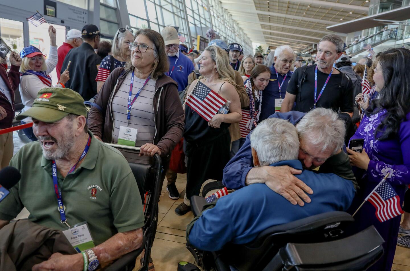 Navy Veterans greet supporters after arriving back in San Diego from an Honor Flight tour, at the San Diego International Airport on Sunday, April 28, 2024.