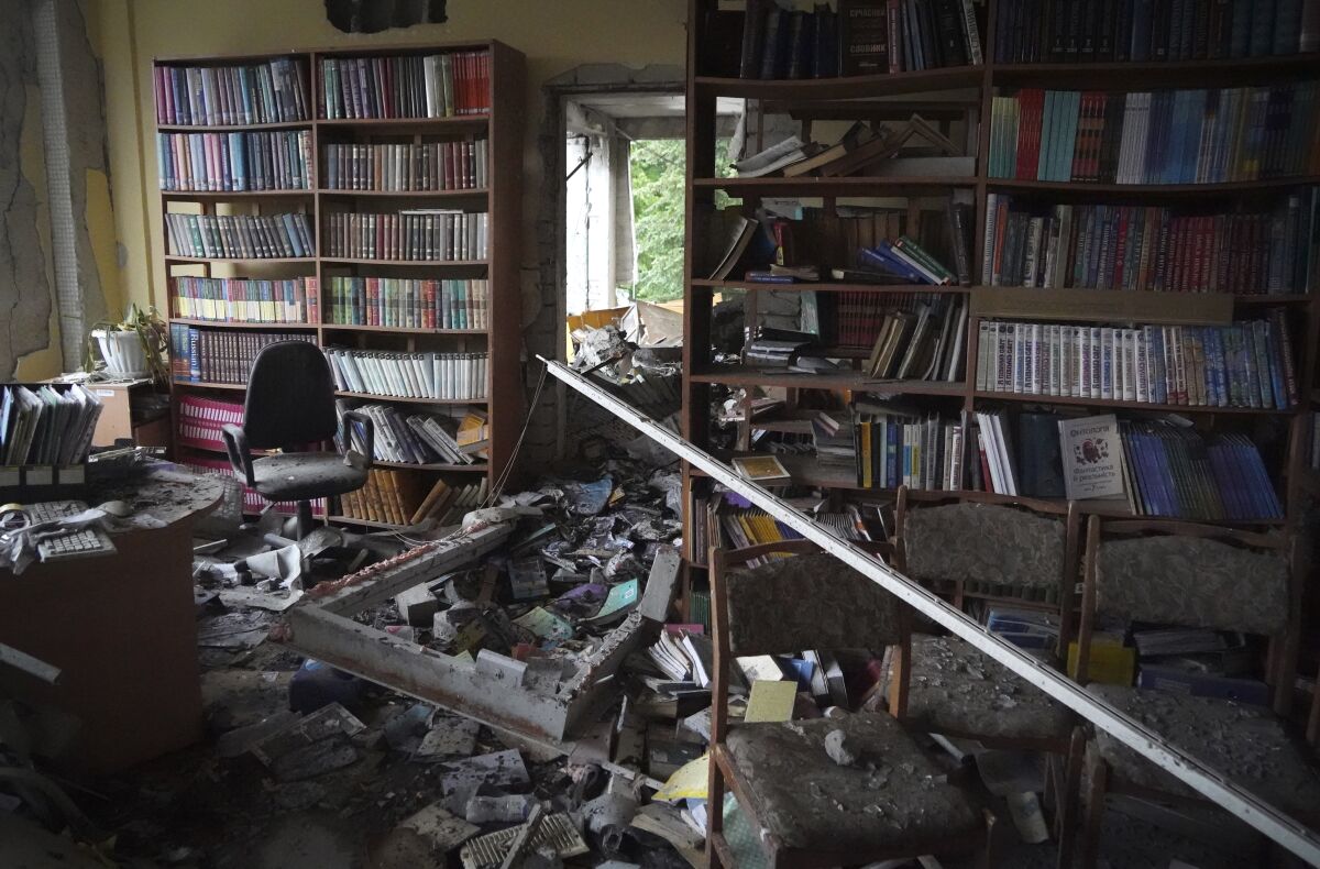 Destroyed library in the school where a graduation ceremony, called the Last School Bell, was supposed to take place in Kharkiv, Ukraine, Thursday, June 2, 2022. (AP Photo/Andrii Marienko)