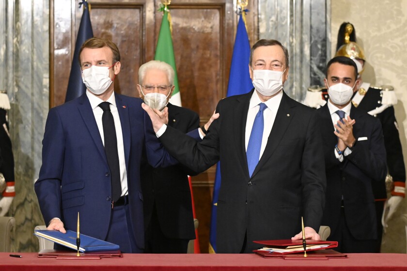 France's President Emmanuel Macron, left, and Italy's Prime Minister Mario Draghi sign the Franco-Italian Quirinal Treaty next to Italy's President Sergio Mattarella, second left, and Italy's Foreign Minister Luigi Di Maio, right, at the Quirinale presidential palace in Rome, Friday, Nov. 26, 2021. (Alberto Pizzoli / Pool photo via AP)