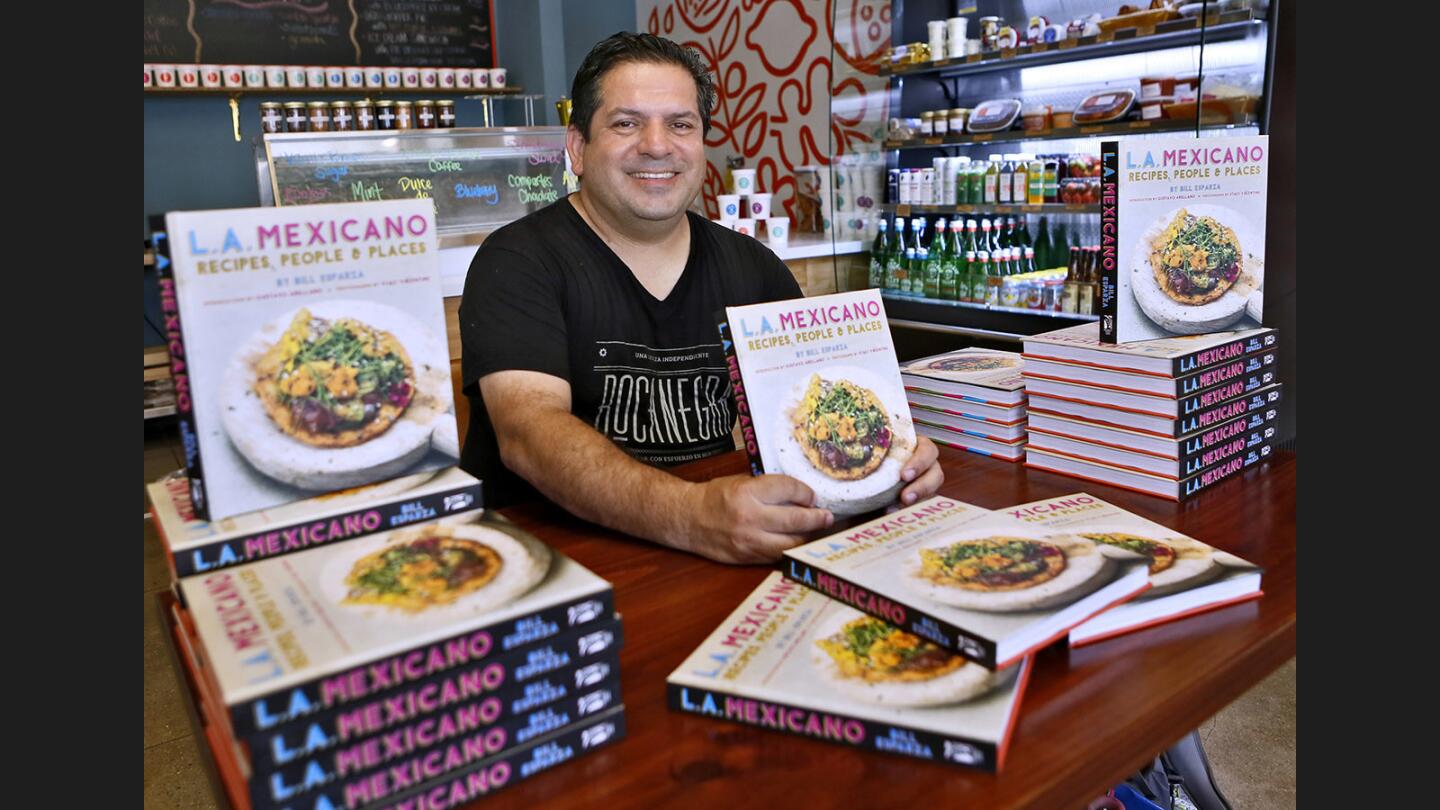 John Muir Middle School teacher Bill Esparza signs his new book, L.A. Mexicano, Recipes, People and Places, at Friends and Family Restaurant, on Hollywood Blvd. in Los Angeles on Saturday, July 8, 2017. Esparza, who lives in Hollywood, has been teaching at Burbank Unified School District for about 15 years, and is also a leading authority on Latin American cuisine.