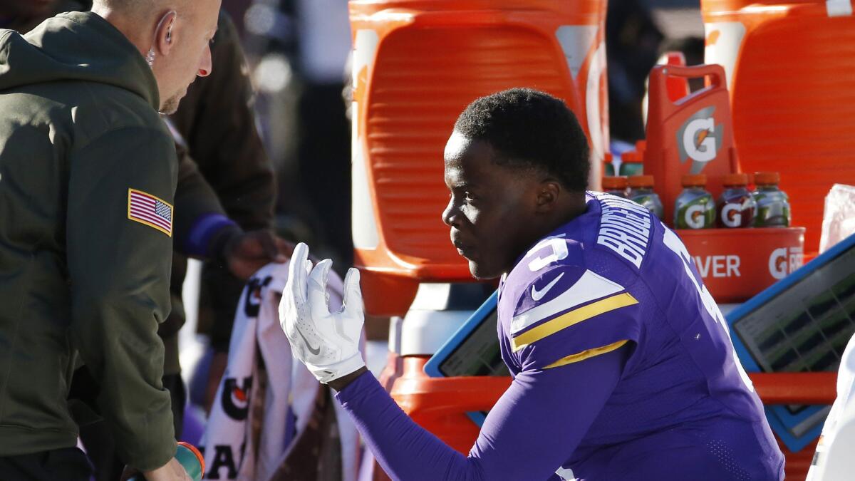 Vikings quarterback Teddy Bridgewater sits on the bench after taking a hit to the helmet during the second half of a game against the St. Louis Rams on Sunday in Minneapolis.