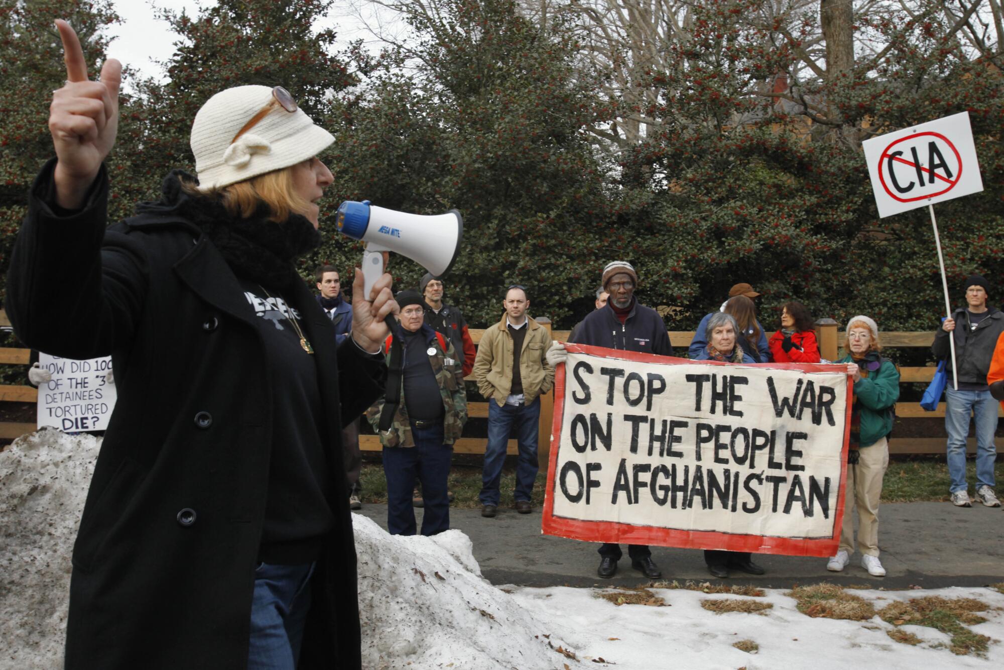 Cindy Sheehan points down the road toward former Vice President Dick Cheney's house during an antiwar protest in 2010.