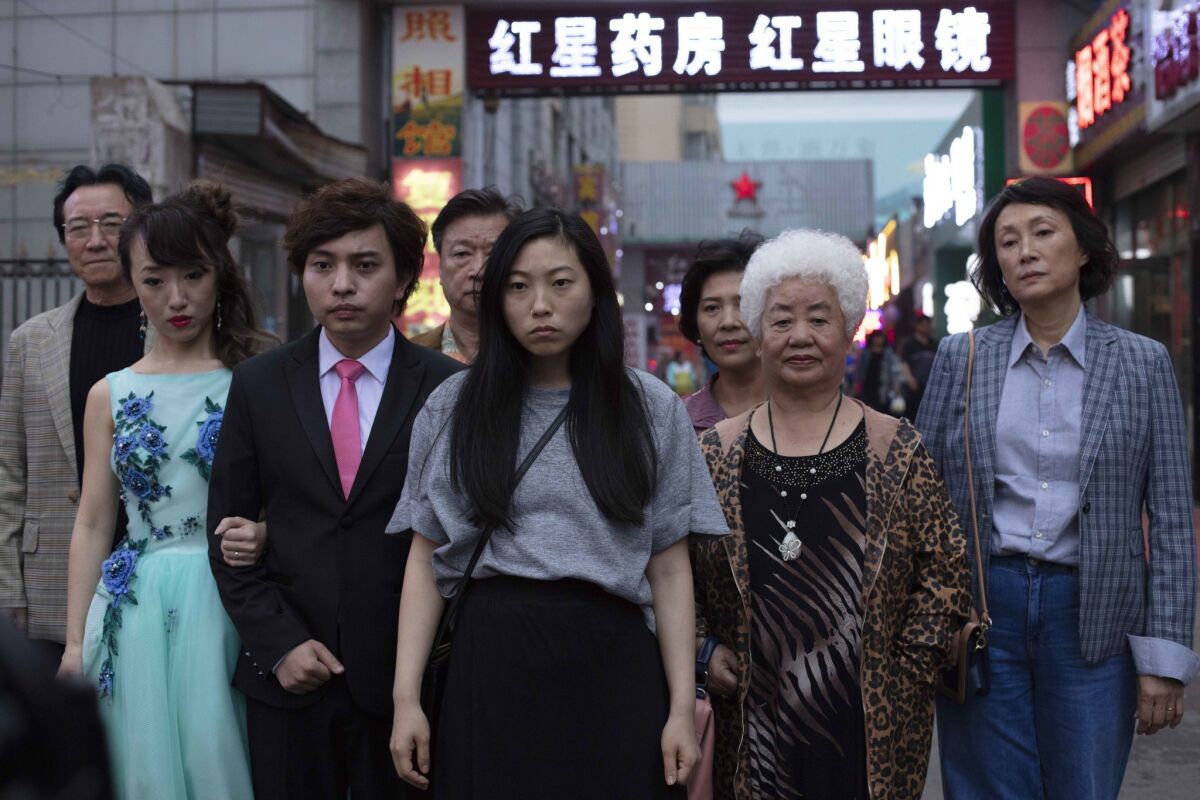 Cast members, including Awkwafina, center, in a scene from the A24 movie "The Farewell."