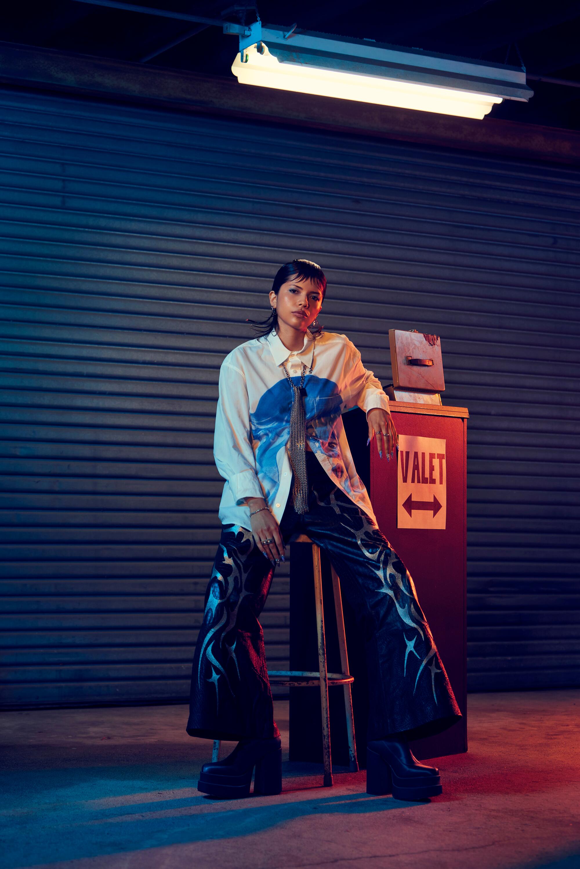 A model dressed as a valet sits beside a "Valet" sign.