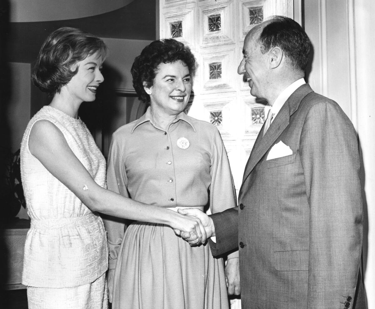 Diana Lynn, left, and Mercedes McCambridge greet Adlai E. Stevenson at Miss Lynn's Beverly Hills home.