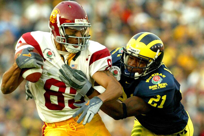 Keary Colbert makes a one-handed catch against Michigan defensive back Jeremy LeSueur to score a touchdown in the Rose Bowl game on Jan. 1, 2004.