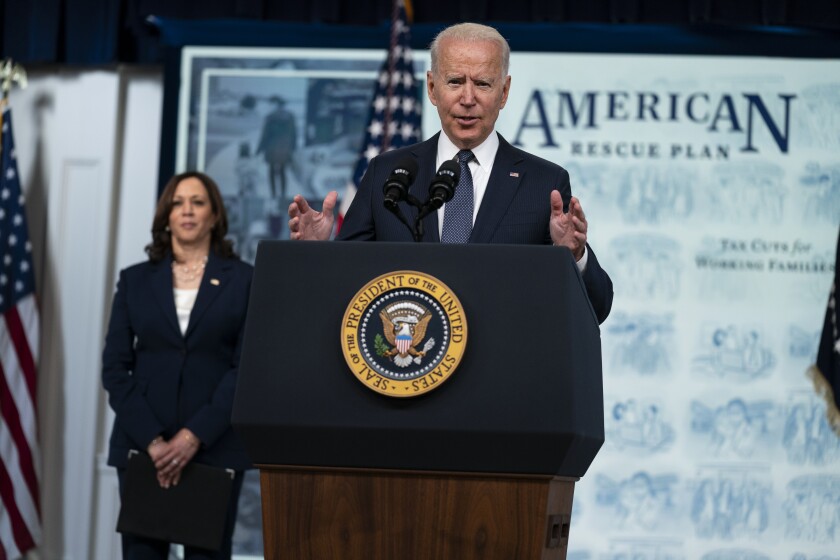 Vice President Kamala Harris listens as President Joe Biden speaks during an event to mark the start of monthly Child Tax Credit relief payments, in the South Court Auditorium on the White House complex, Thursday, July 15, 2021, in Washington. (AP Photo/Evan Vucci)
