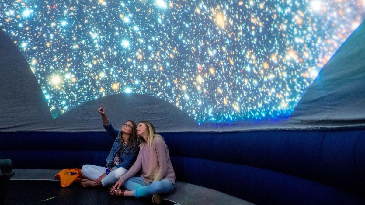 Children engage in a stargazing activity onboard Grand Princess.