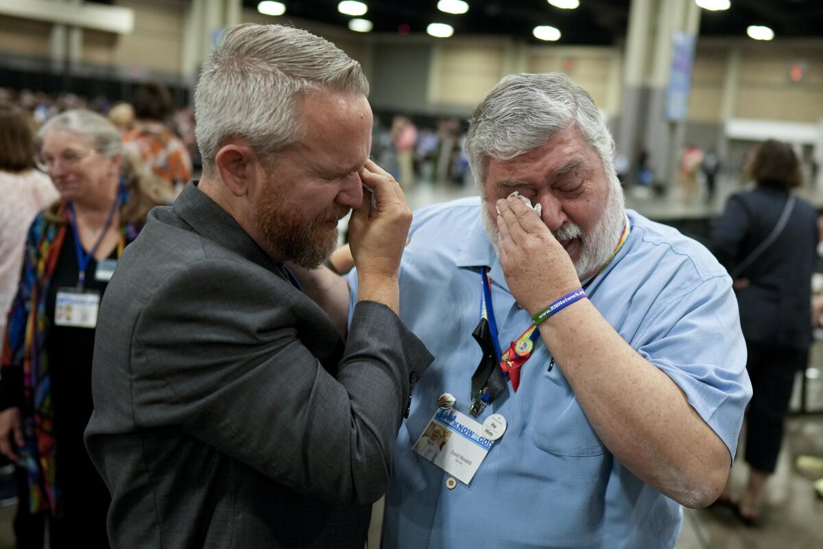 Two men wiping away tears