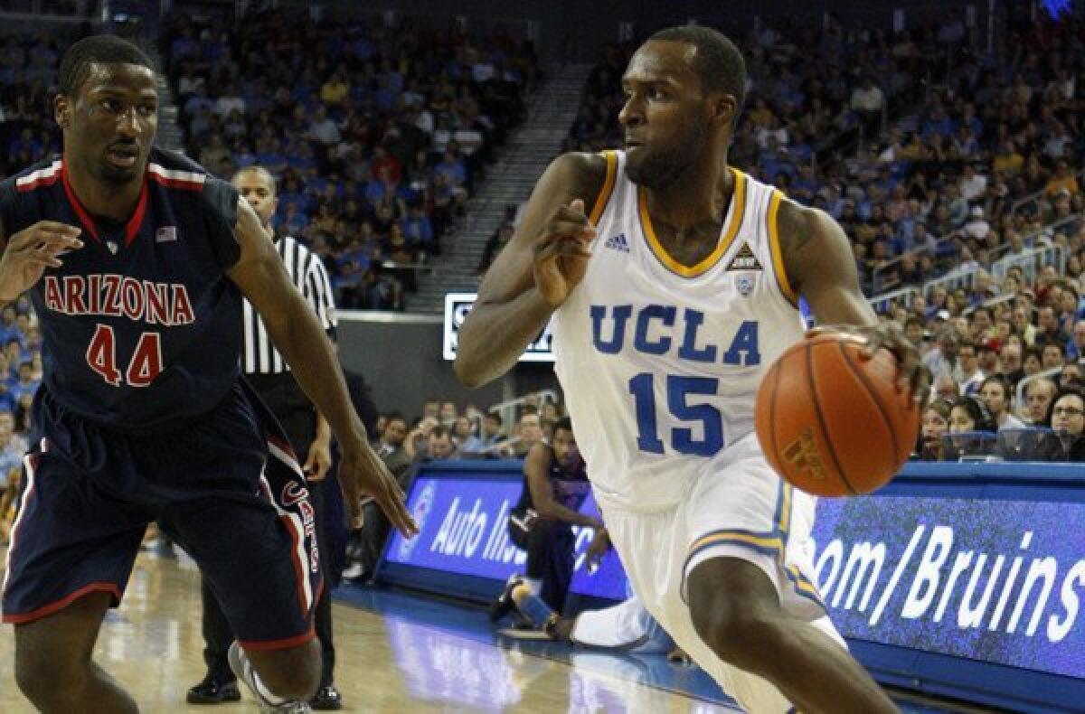 Shabazz Muhammad drives against Arizona's Solomon Hill in a game at Pauley Pavilion.