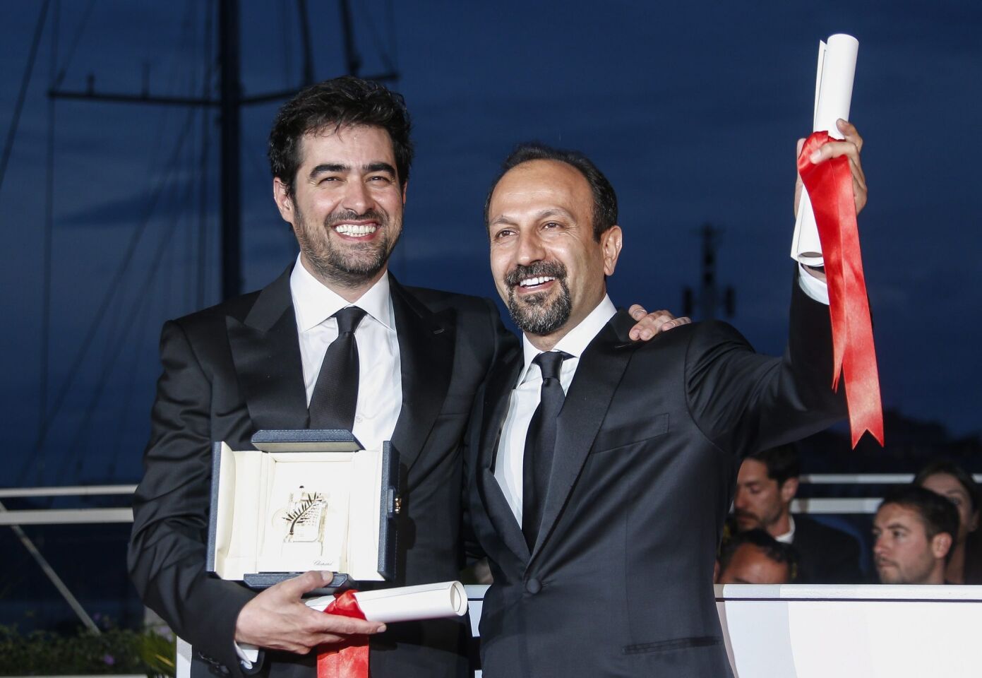 Iranian director Ashgar Farhadi, right, and Iranian actor Shahab Hosseini pose during the award winners photo call after they won the Best Screenplay award and the Best Performance by an Actor award for the movie "Forushande" ("The Salesman").
