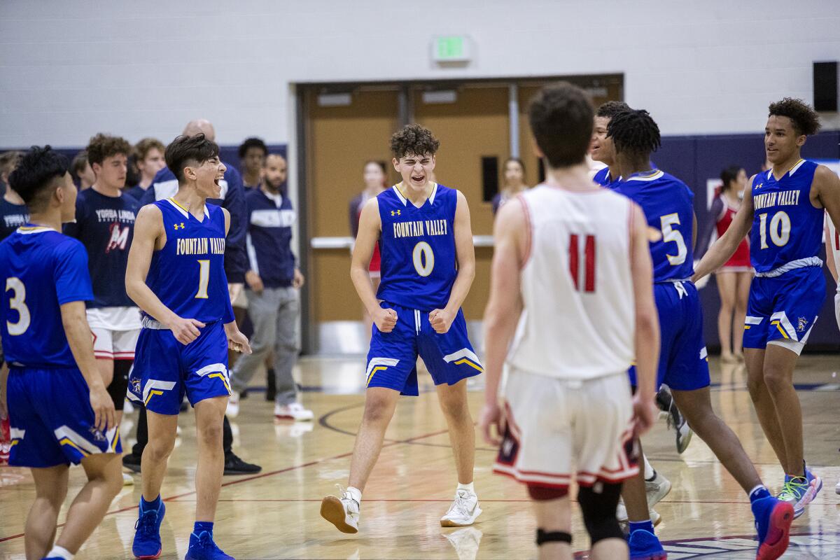 Fountain Valley’s Preston Amarillo (0) and his teammates celebrate late in a CIF Southern Section Division 3A quarterfinal playoff game at Yorba Linda on Feb. 18.