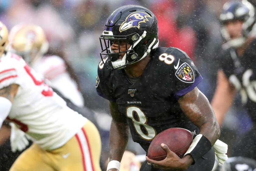 BALTIMORE, MARYLAND - DECEMBER 01: Quarterback Lamar Jackson #8 of the Baltimore Ravens runs for a first half touchdown against the San Francisco 49ers in the first half at M&T Bank Stadium on December 01, 2019 in Baltimore, Maryland. (Photo by Rob Carr/Getty Images)