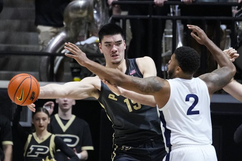 Purdue center Zach Edey (15) makes a pass around Penn State guard Myles Dread (2) during the first half of an NCAA college basketball game in West Lafayette, Ind., Wednesday, Feb. 1, 2023. (AP Photo/Michael Conroy)