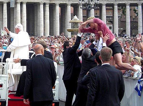 Bodyguards block a 27-year-old German man from leaping toward Pope Benedict XVI's jeep Wednesday at the start of his general audience in St. Peter's Square in Vatican City. Officials at the Vatican declined to identify the man, but the Rev. Federico Lombardi, the pope's spokesman, said the man was not armed. "He was clearly deranged but did not want to kill or harm the pope," Lombardi told reporters. "He only wanted to draw attention to himself." The assailant was taken to a hospital for psychiatric treatment. Although no one was injured, and the 80-year-old pontiff seemed unaware of the disturbance, the incident invoked memories of the assassination attempt against the pope's predecessor, Pope John Paul, in 1981 when Turkish gunman Mehmet Ali Agca shot and seriously wounded the pope, also in St. Peter's Square.