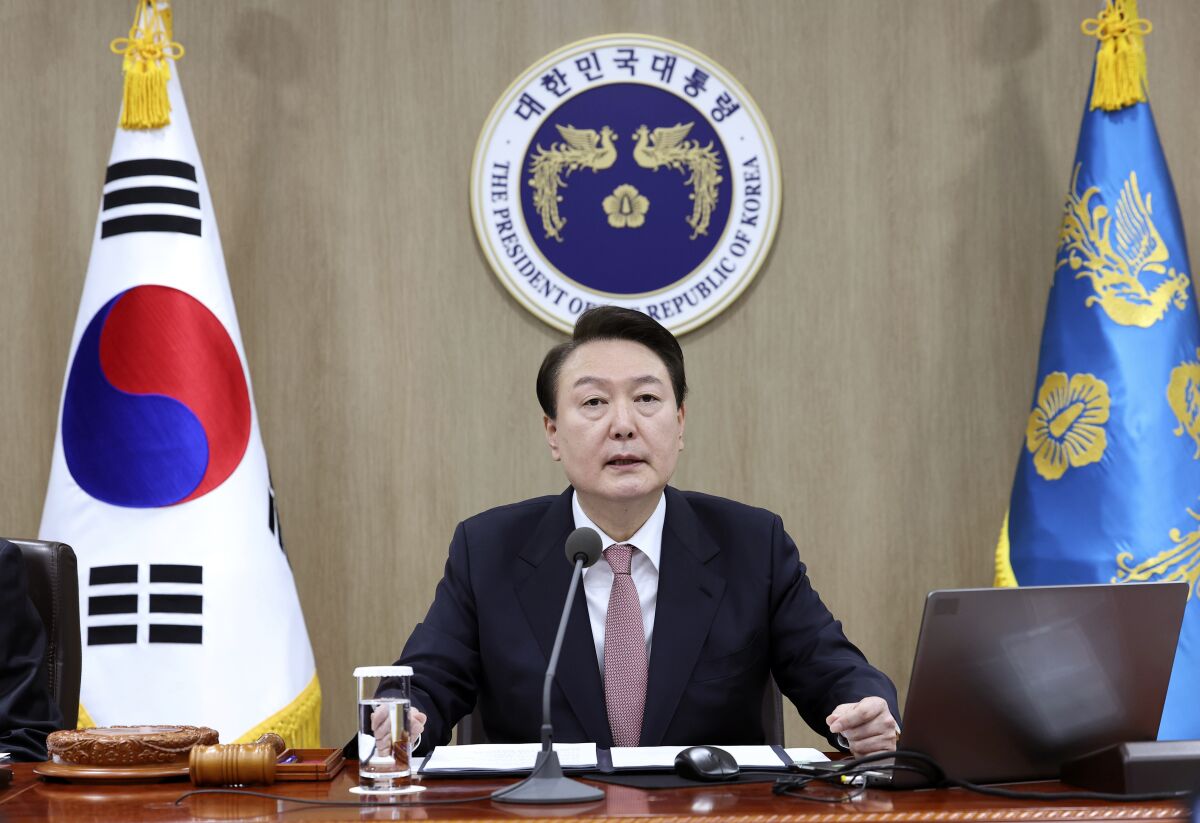 South Korean President Yoon Suk Yeol speaks during a Cabinet meeting at the president office in Seoul, South Korea, Tuesday, March 21, 2023. President Yoon said Tuesday his government will take steps to restore Japan’s preferential trade status as he's trying to push for his contentious bid to resolve fraught ties with Japan despite domestic opposition.(Lim Hun-jung/Yonhap via AP)
