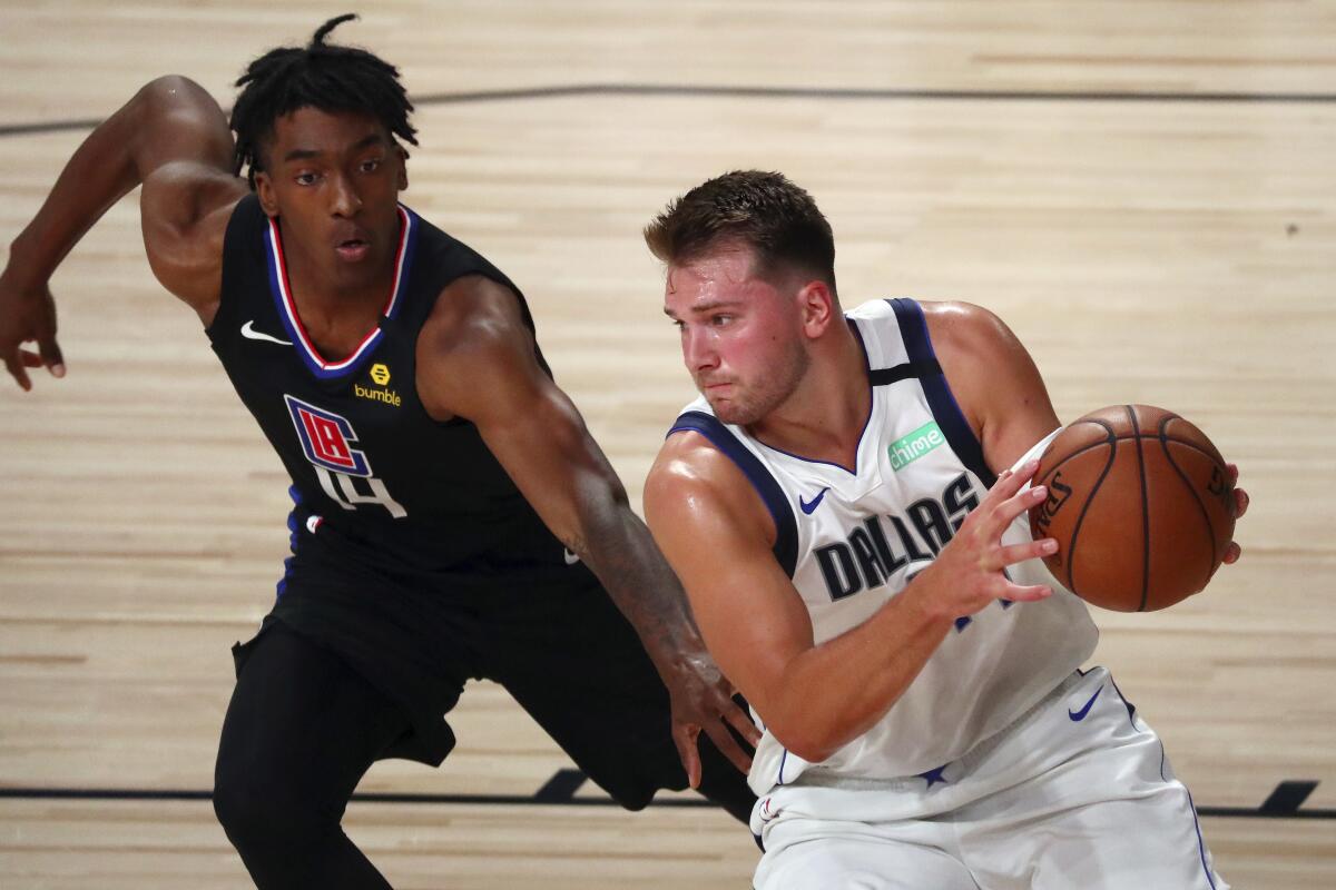 Dallas Mavericks guard Luka Doncic drives to the basket against Clippers guard Terance Mann 