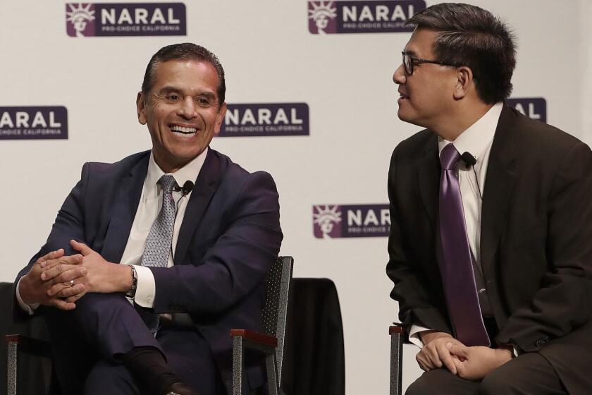 Democratic Candidates for California Governor Villaraigosa, left, smiles next to John Chiang at a NARAL Pro-Choice California event in San Francisco, Tuesday, Jan. 30, 2018. (AP Photo/Jeff Chiu)