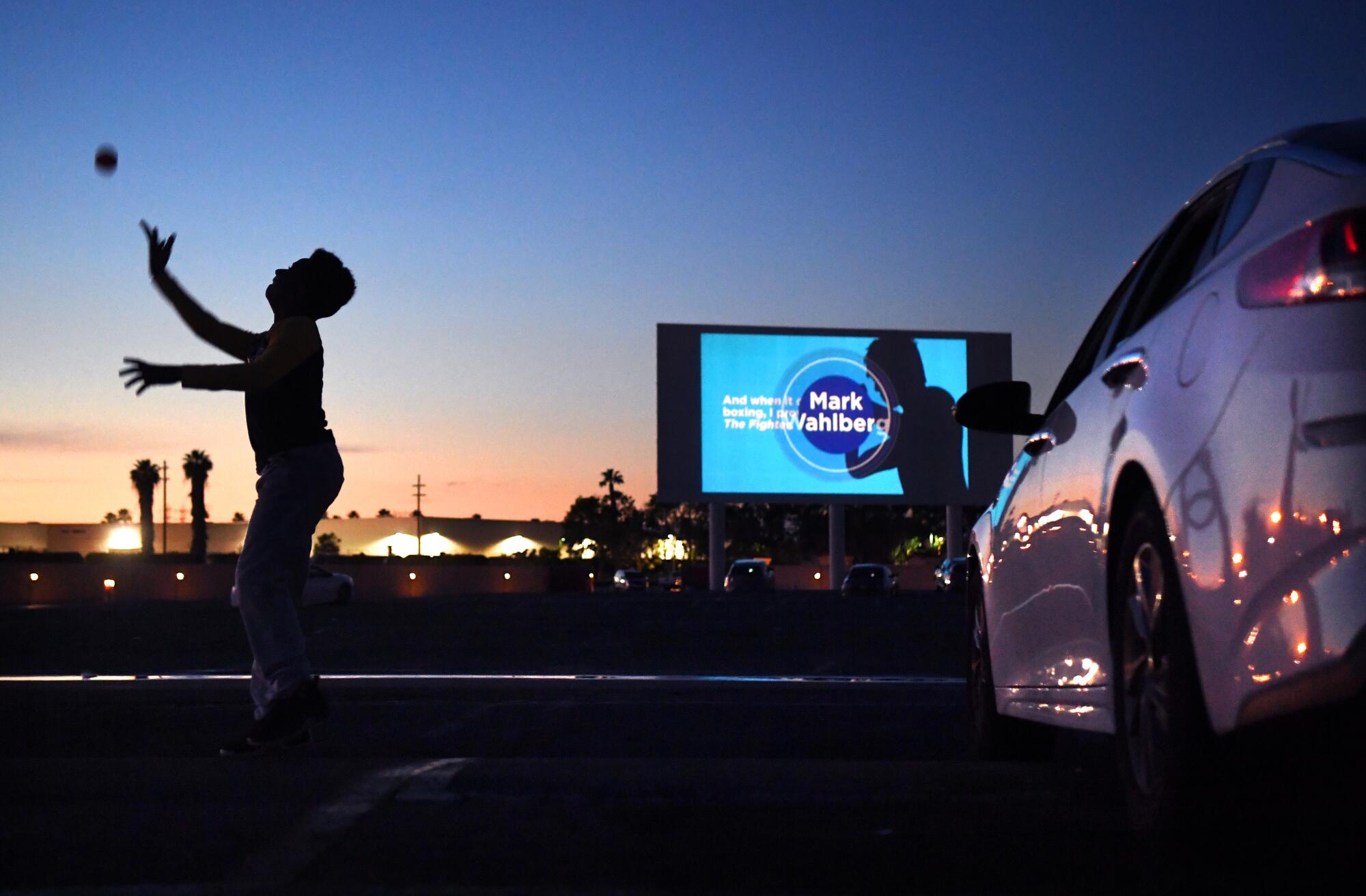 Michael Ray, 11, plays with a ball before a movie at the Paramount Drive-In. 