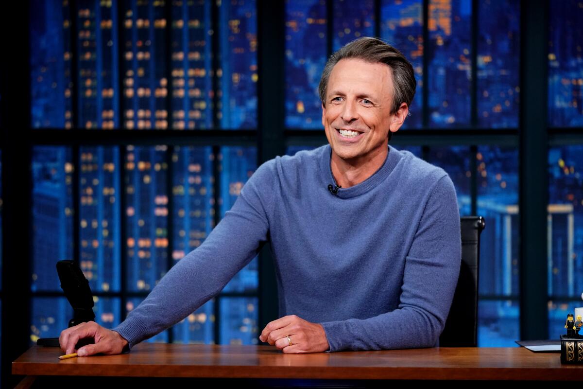 Man in blue shirt at desk