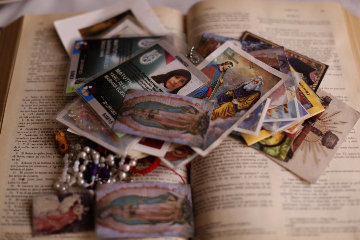 The school ID card of Mariana Yañez sits on top of a Bible at the home of the slain teenager's parents in Ecatepec, Mexico.