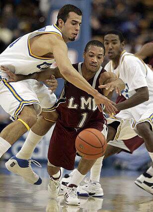 UCLA's Nikola Dragovic, left, steals the ball from Corey Counts of Loyola Marymount in the second half Wednesday night.